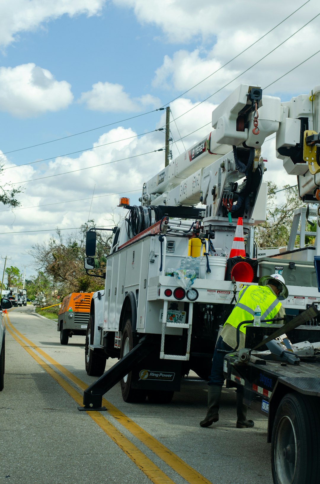 Photo by cody reed a white utility truck parked on the side of a road